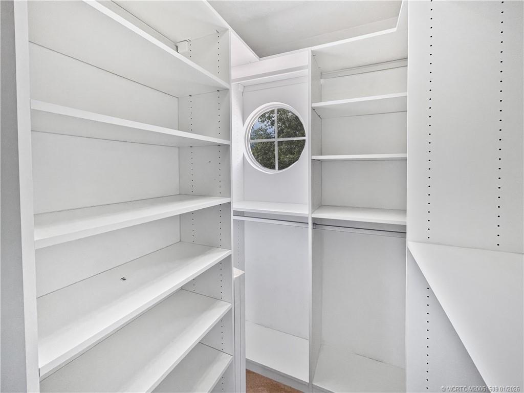 8006 Southwest Yachtsmans Drive Stuart, FL 34997 - Photo 11 of 42 a view of walk in closet with empty racks