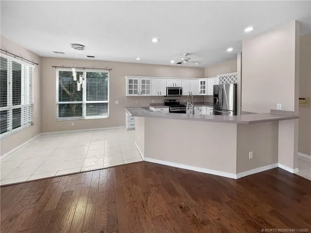a kitchen with stainless steel appliances a refrigerator and microwave