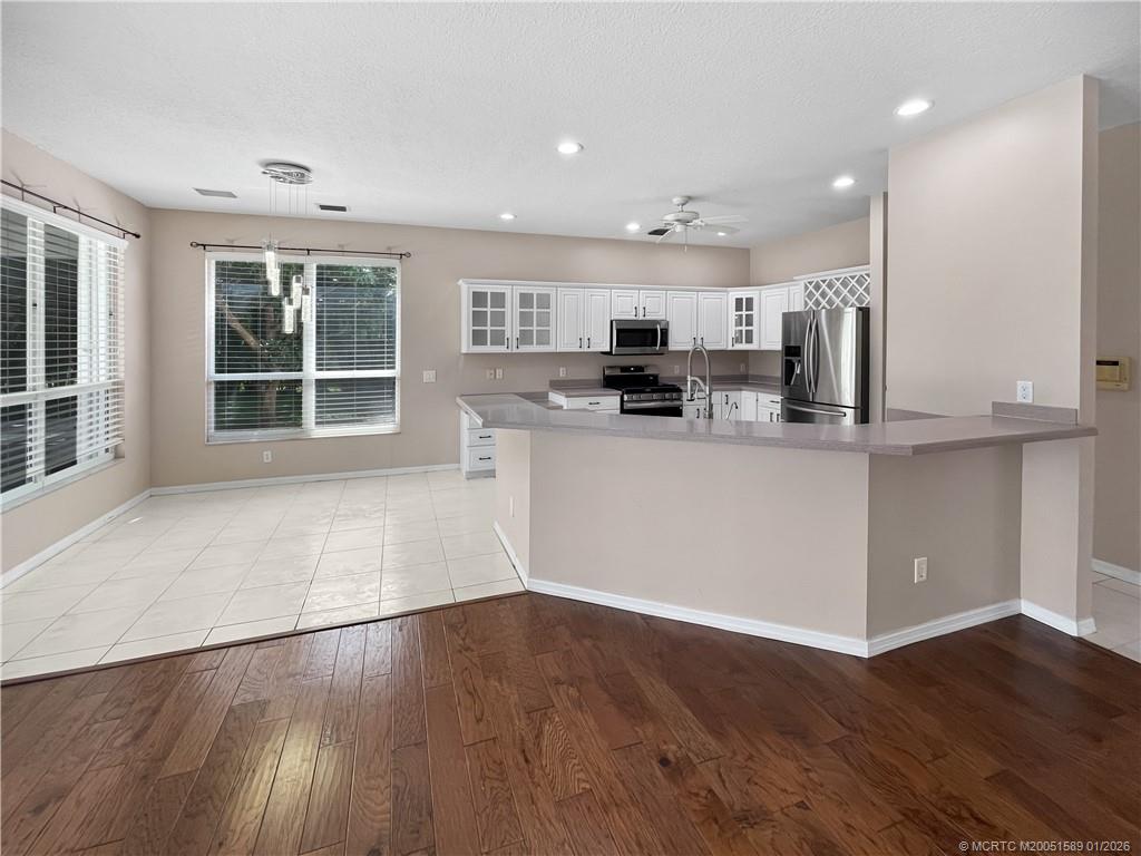 8006 Southwest Yachtsmans Drive Stuart, FL 34997 - Photo 27 of 42 a kitchen with stainless steel appliances a refrigerator and microwave