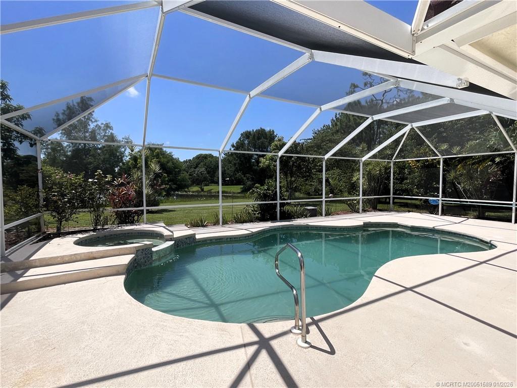 8006 Southwest Yachtsmans Drive Stuart, FL 34997 - Photo 2 of 42 a view of a swimming pool with a patio and a yard