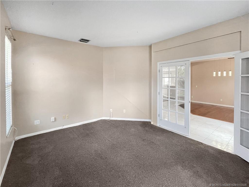 8006 Southwest Yachtsmans Drive Stuart, FL 34997 - Photo 32 of 42 a view of an empty room with a window