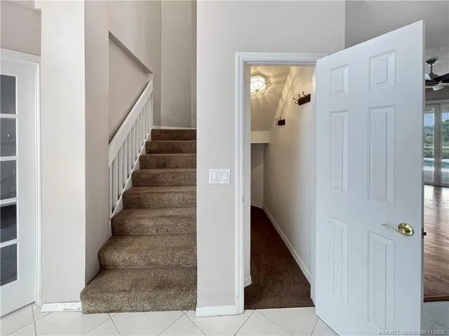 a view of a hallway with wooden floor and entryway