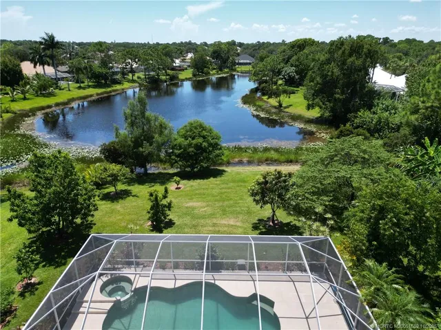 an aerial view of residential house with yard and green space