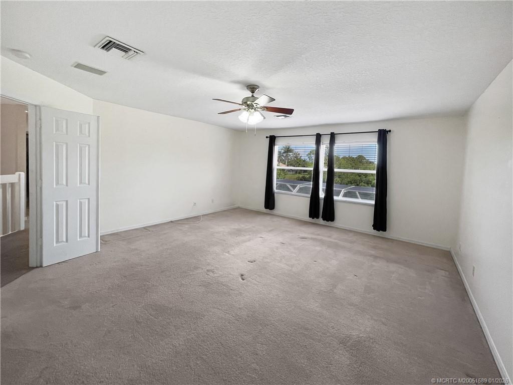 8006 Southwest Yachtsmans Drive Stuart, FL 34997 - Photo 9 of 42 a view of a big room with chandelier fan and windows