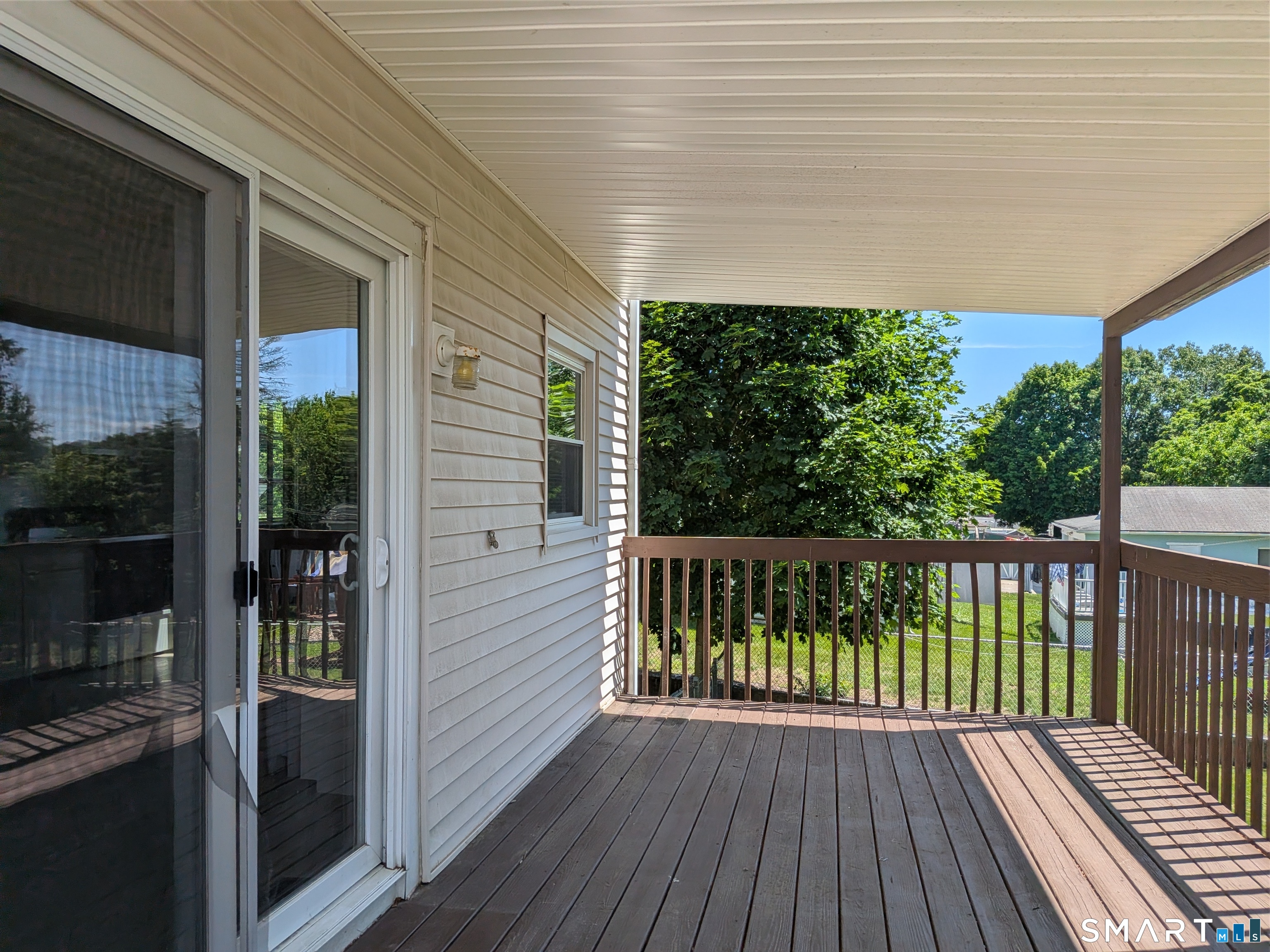 124 Spring Lake Road Waterbury, CT 06706 - Photo 30 of 34 Slider leads from kitchen to covered deck