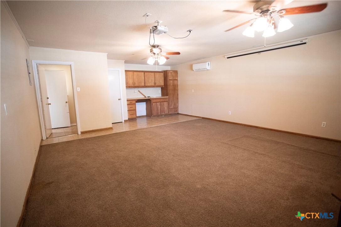 712 Brazos Drive Temple, TX 76504 - Photo 14 of 28 an empty room with a chandelier fan and windows