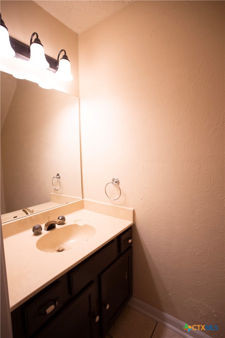 712 Brazos Drive Temple, TX 76504 - Photo 15 of 28 a bathroom with a sink and a mirror