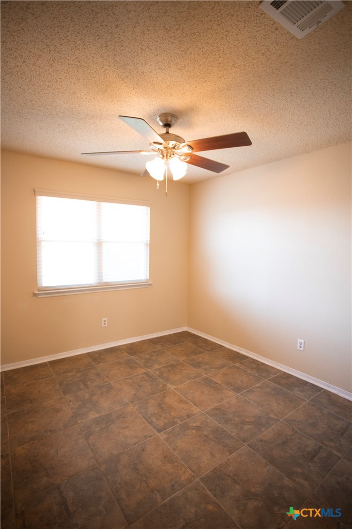 712 Brazos Drive Temple, TX 76504 - Photo 22 of 28 an empty room with a window and a ceiling fan