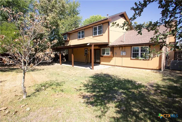 a front view of a house with a yard covered in snow