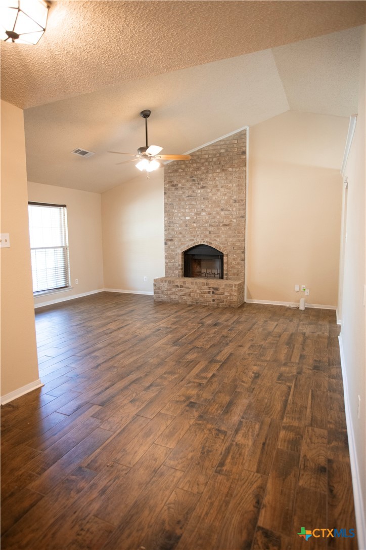 712 Brazos Drive Temple, TX 76504 - Photo 6 of 28 a view of empty room with wooden floor and fireplace
