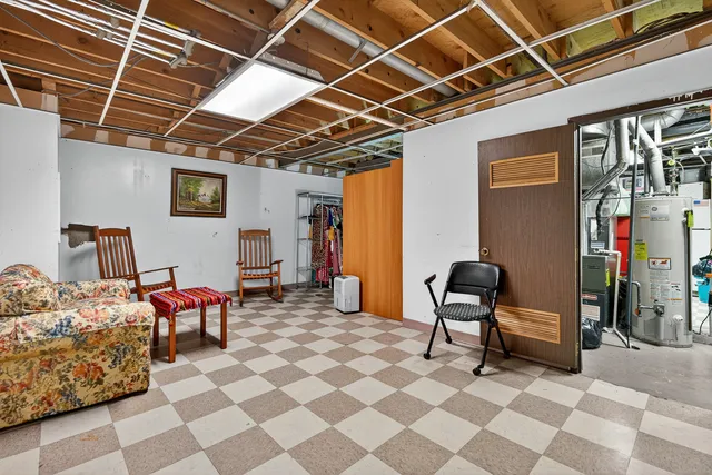 a bed room with a bed and a chair