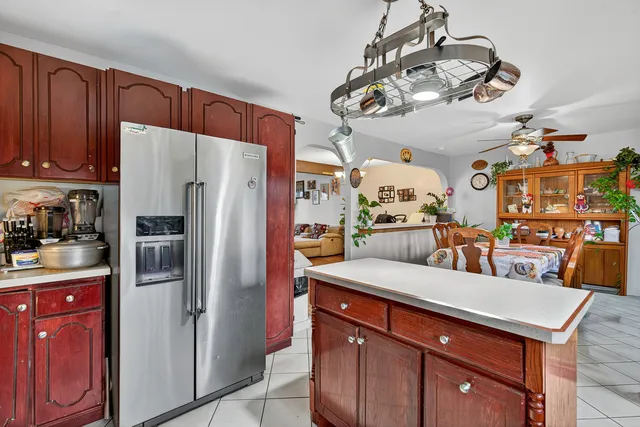 a kitchen with a sink a counter space appliances and cabinets