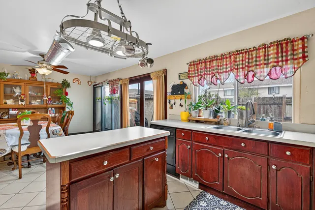 a dining room with furniture a flat screen tv and a large window