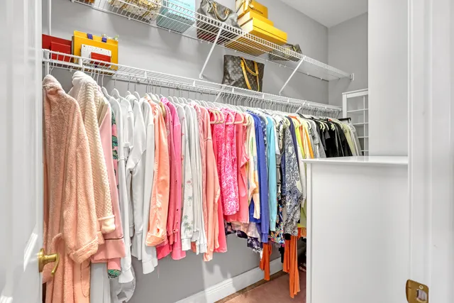 a bedroom with a bed table chair and a window