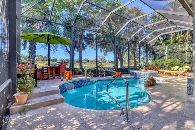 an aerial view of residential houses with outdoor space and river