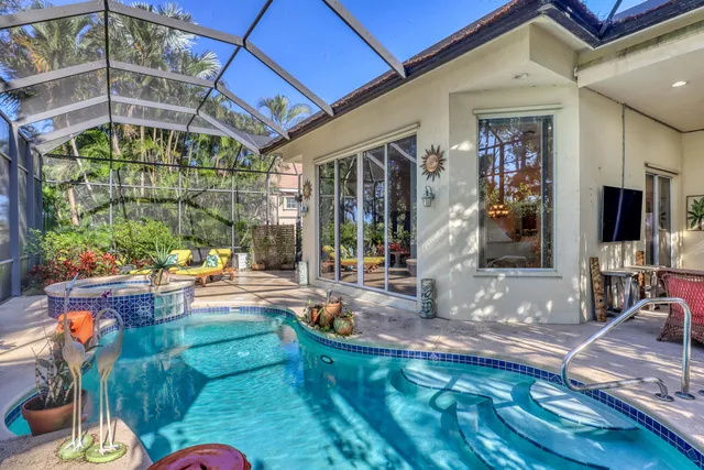 an aerial view of a house with a swimming pool yard and lake view