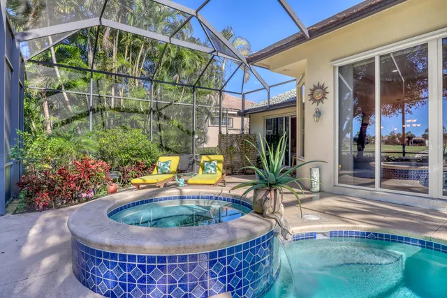 an aerial view of a house with a swimming pool yard and mountain view in back