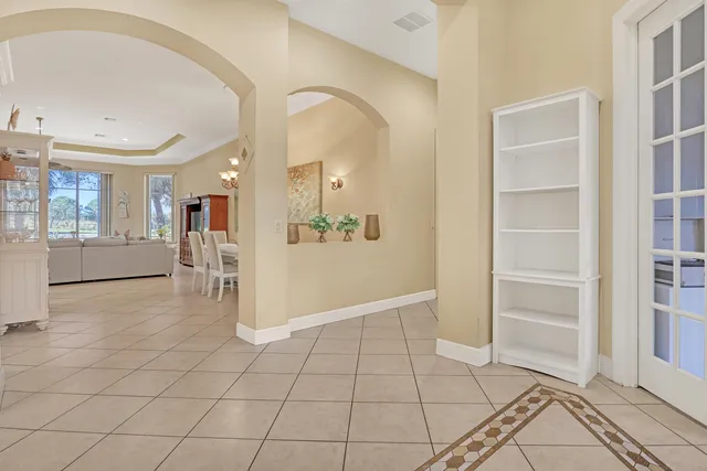 a view of a dining room with furniture and chandelier