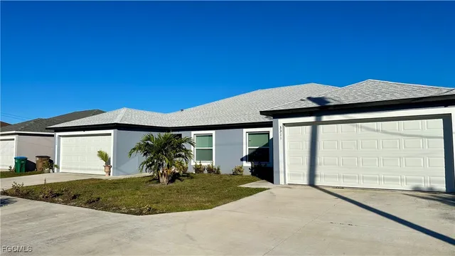 a view of a house with a backyard and porch