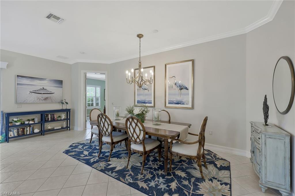 5012 Maxwell Circle, Unit 101 Naples, FL 34105 - Photo 11 of 23 a dining room with furniture a rug and wooden floor