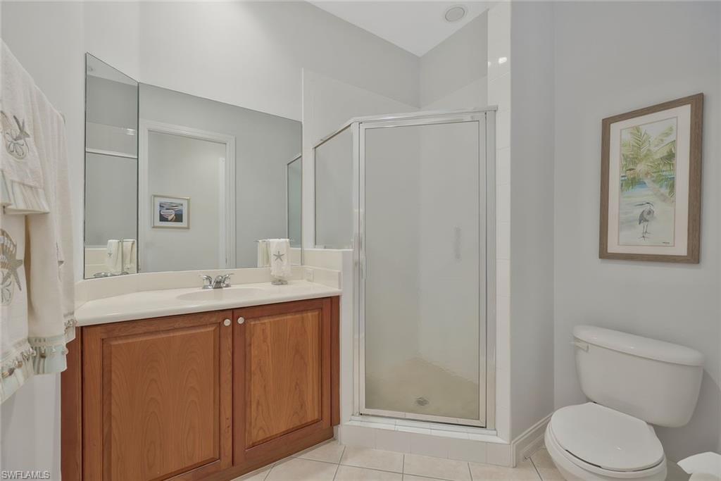 5012 Maxwell Circle, Unit 101 Naples, FL 34105 - Photo 16 of 23 a bathroom with a toilet a sink and mirror