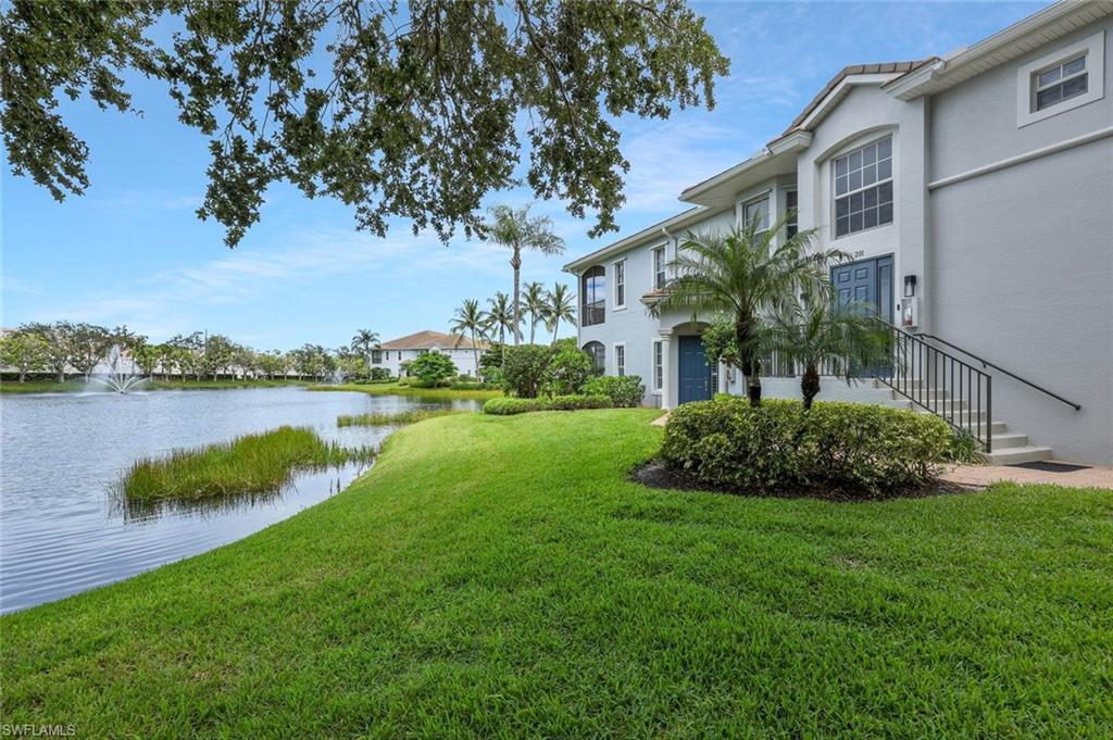 5012 Maxwell Circle, Unit 101 Naples, FL 34105 - Photo 6 of 23 a view of a house with a yard and a pond
