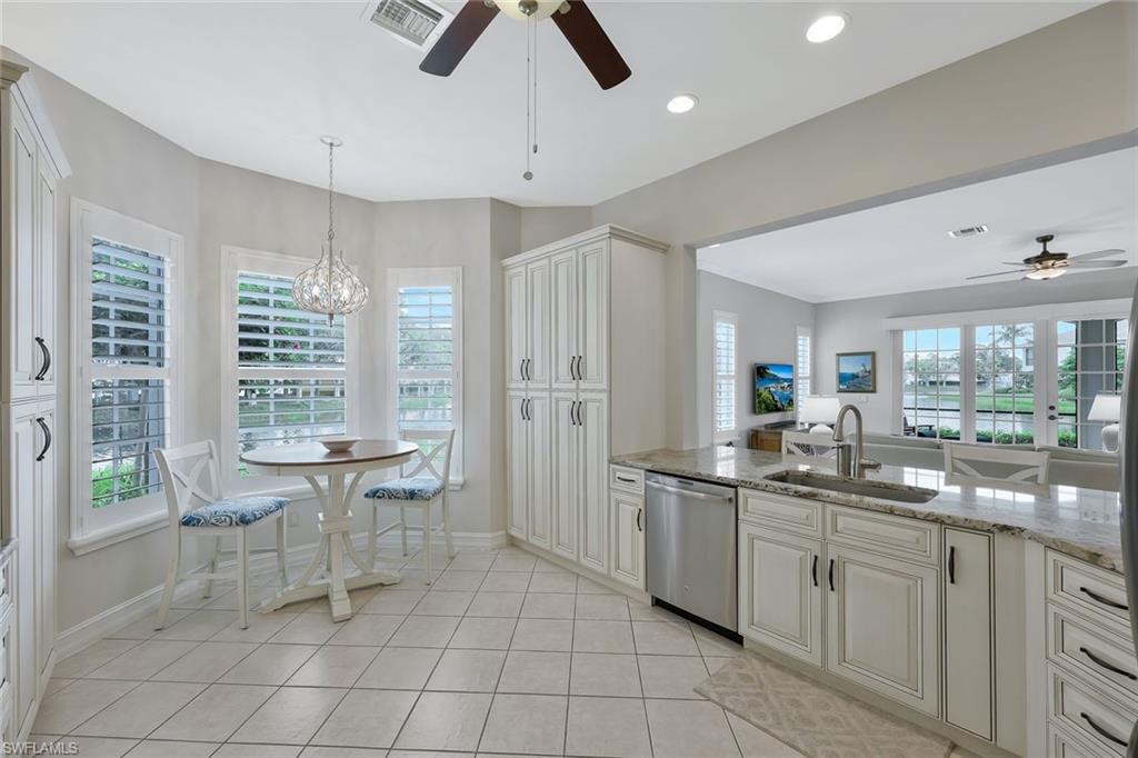 5012 Maxwell Circle, Unit 101 Naples, FL 34105 - Photo 9 of 23 a kitchen with stainless steel appliances a sink and cabinets