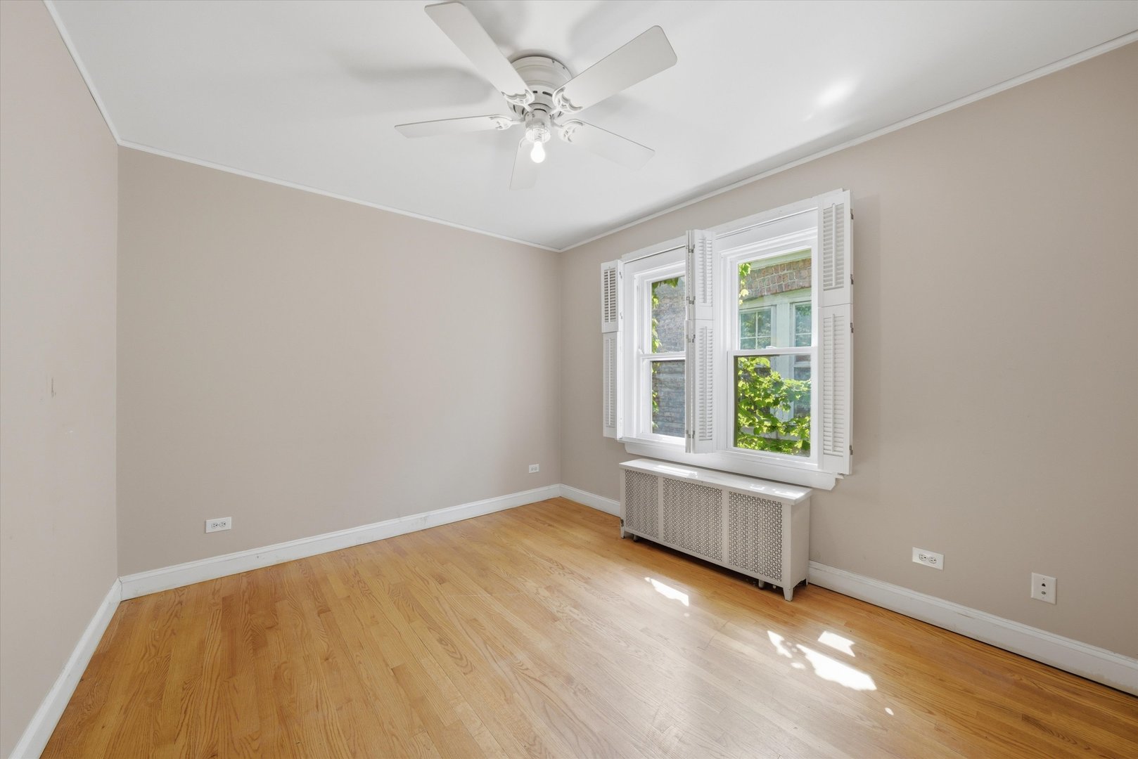 3100 Clinton Avenue Berwyn, IL 60402 - Photo 12 of 25 an empty room with windows and ceiling fan