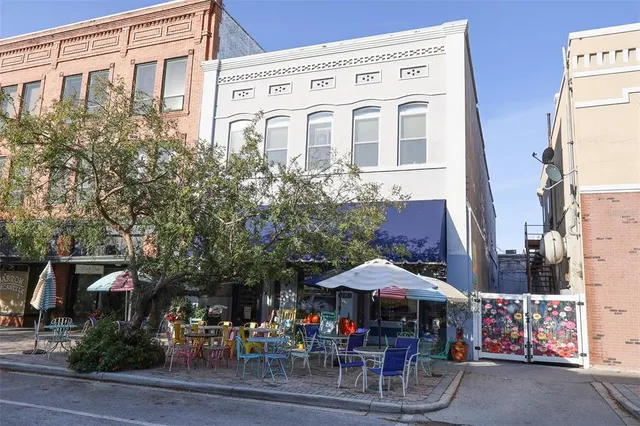 a front view of a building with umbrellas