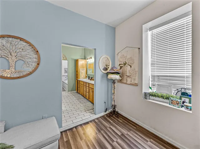 a bathroom with a tub sink and mirror