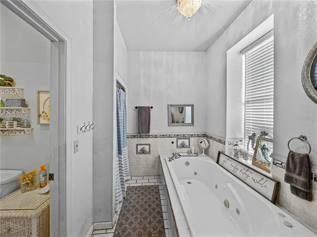 a living room with lots of furniture and kitchen view