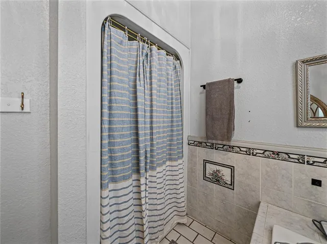 a kitchen with granite countertop a refrigerator stove and cabinets