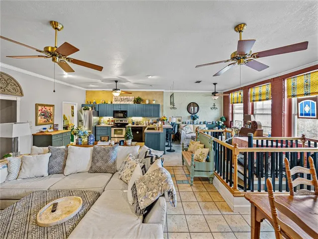 a living room with lots of furniture and a large window