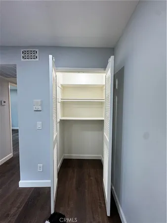a view of walk in closet with empty racks