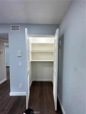 a view of walk in closet with empty racks