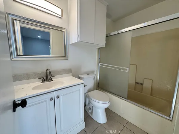 a bathroom with a toilet sink and vanity