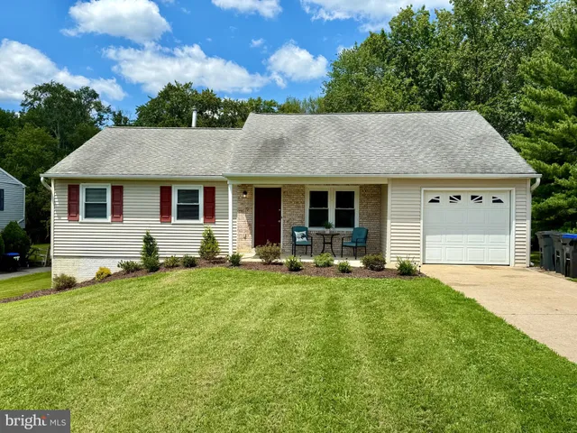 a front view of house with yard and seating area