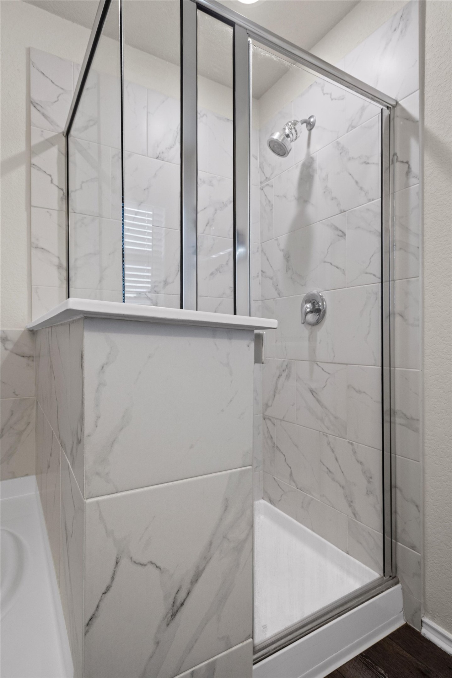 145 Fiery Skipper Lane Georgetown, TX 78626 - Photo 22 of 29 Primary Bathroom featuring a marble finish shower, wood finished floors, and a garden tub