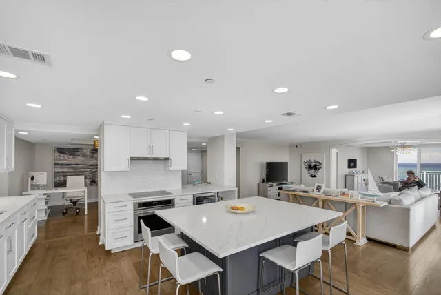 a spacious bedroom with a large bed and a chandelier