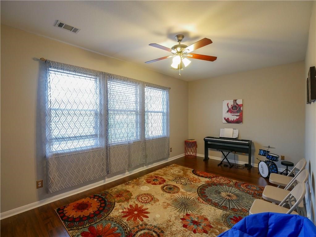 702 South Frontier Lane Cedar Park, TX 78613 - Photo 11 of 30 a bedroom with a bed a dresser and potted plant
