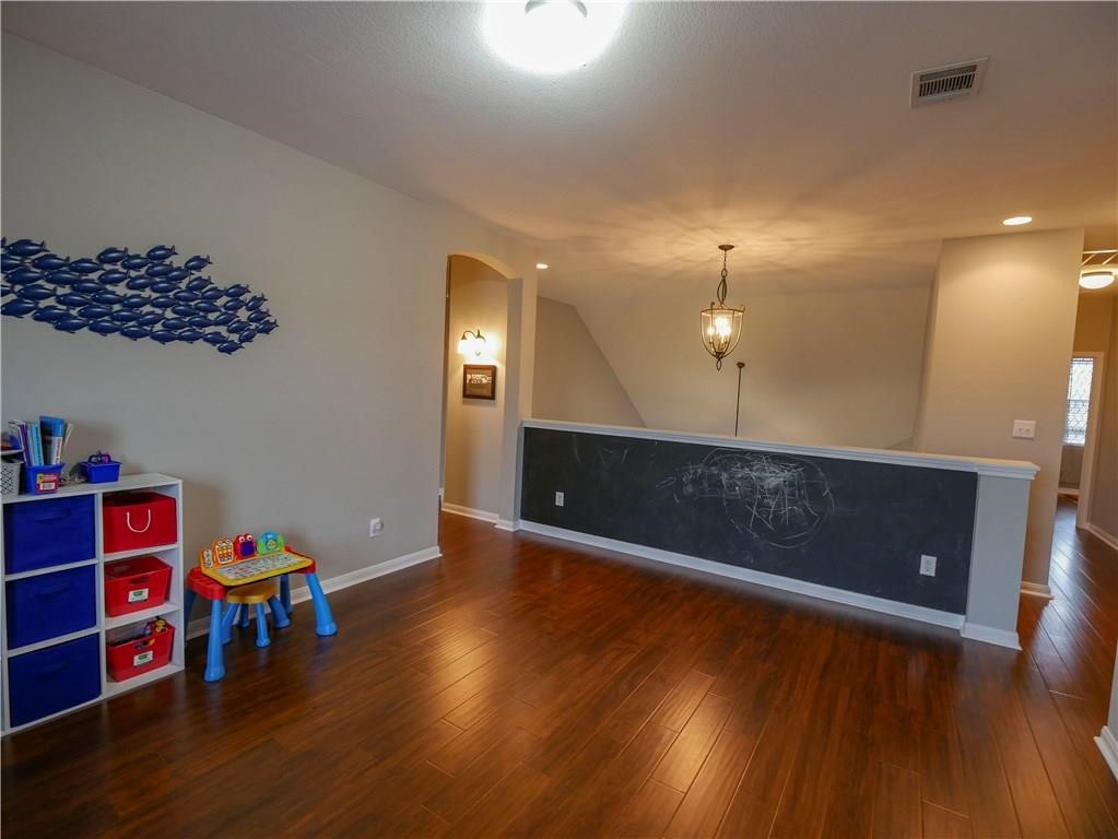 702 South Frontier Lane Cedar Park, TX 78613 - Photo 12 of 30 a view of an empty room with wooden floor and cabinet