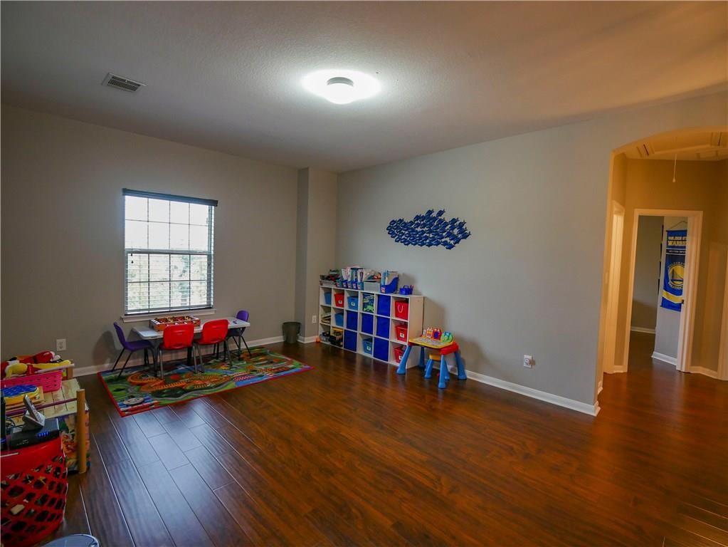 702 South Frontier Lane Cedar Park, TX 78613 - Photo 13 of 30 a living room with lots of furniture and wooden floor