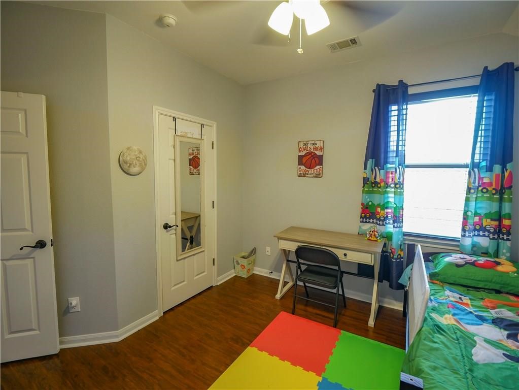 702 South Frontier Lane Cedar Park, TX 78613 - Photo 15 of 30 a room that has a bed and a table in it