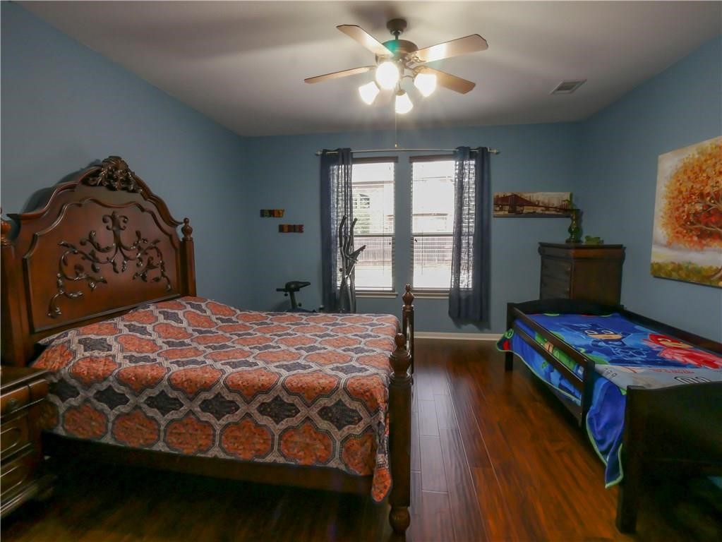702 South Frontier Lane Cedar Park, TX 78613 - Photo 20 of 30 a bedroom with a bed and a window