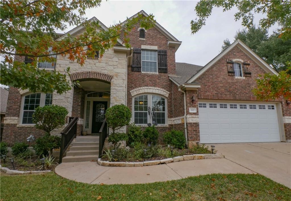 702 South Frontier Lane Cedar Park, TX 78613 - Photo 2 of 30 a front view of a house with a yard and potted plants