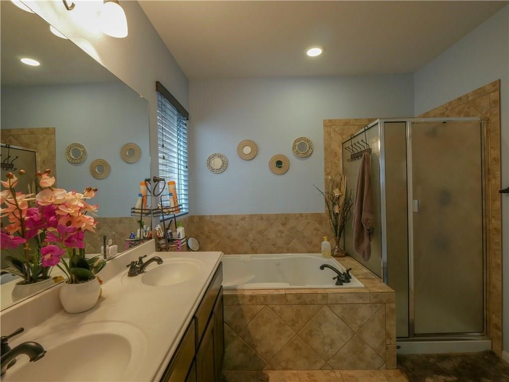 702 South Frontier Lane Cedar Park, TX 78613 - Photo 22 of 30 a bathroom with a tub sink and mirror