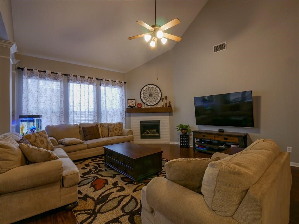 702 South Frontier Lane Cedar Park, TX 78613 - Photo 26 of 30 a living room with furniture a flat screen tv and a fireplace