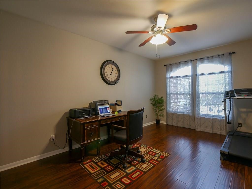 702 South Frontier Lane Cedar Park, TX 78613 - Photo 27 of 30 a view of workspace with wooden floor windows and a ceiling fan