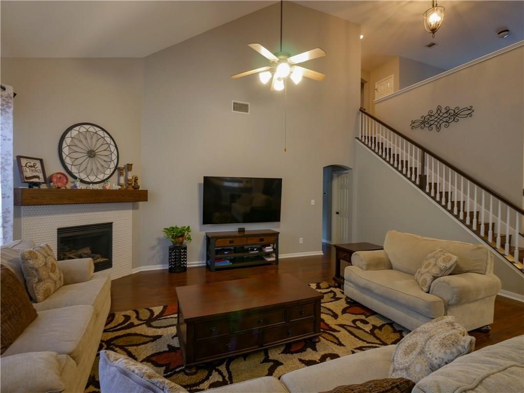 702 South Frontier Lane Cedar Park, TX 78613 - Photo 7 of 30 a living room with furniture a flat screen tv and a fireplace