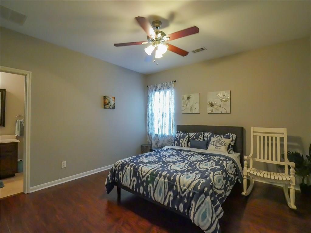702 South Frontier Lane Cedar Park, TX 78613 - Photo 8 of 30 a bedroom with a bed and a ceiling fan